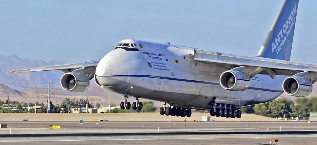 Side view of the An-124 Ruslan during loading, showcasing its massive cargo bay. 