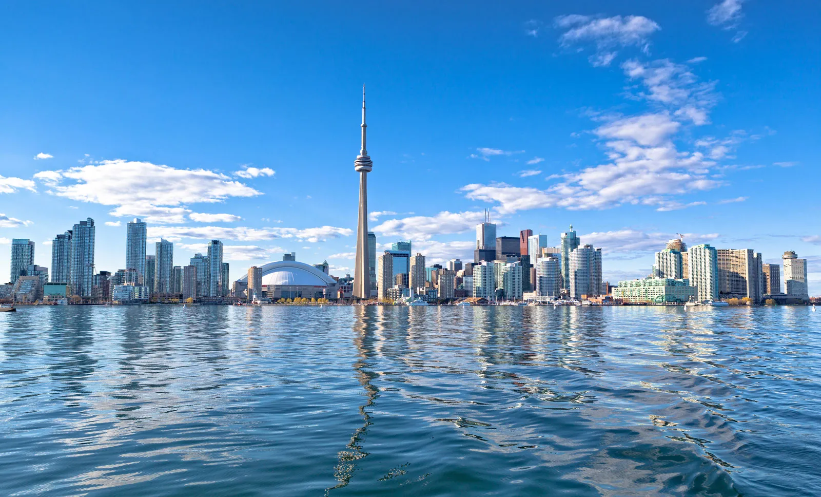 A ferry approaching the Toronto Islands with the city skyline in the background 