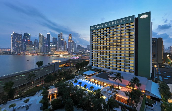 The serene swimming pool at Mandarin Oriental Bangkok surrounded by tropical gardens 