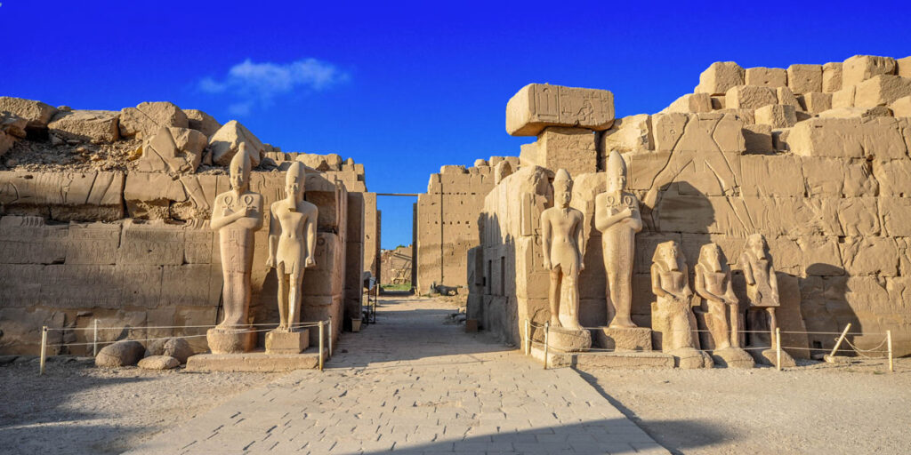 Karnak Temple bathed in golden hues at dawn, showcasing its grandeur