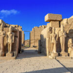 Karnak Temple bathed in golden hues at dawn, showcasing its grandeur